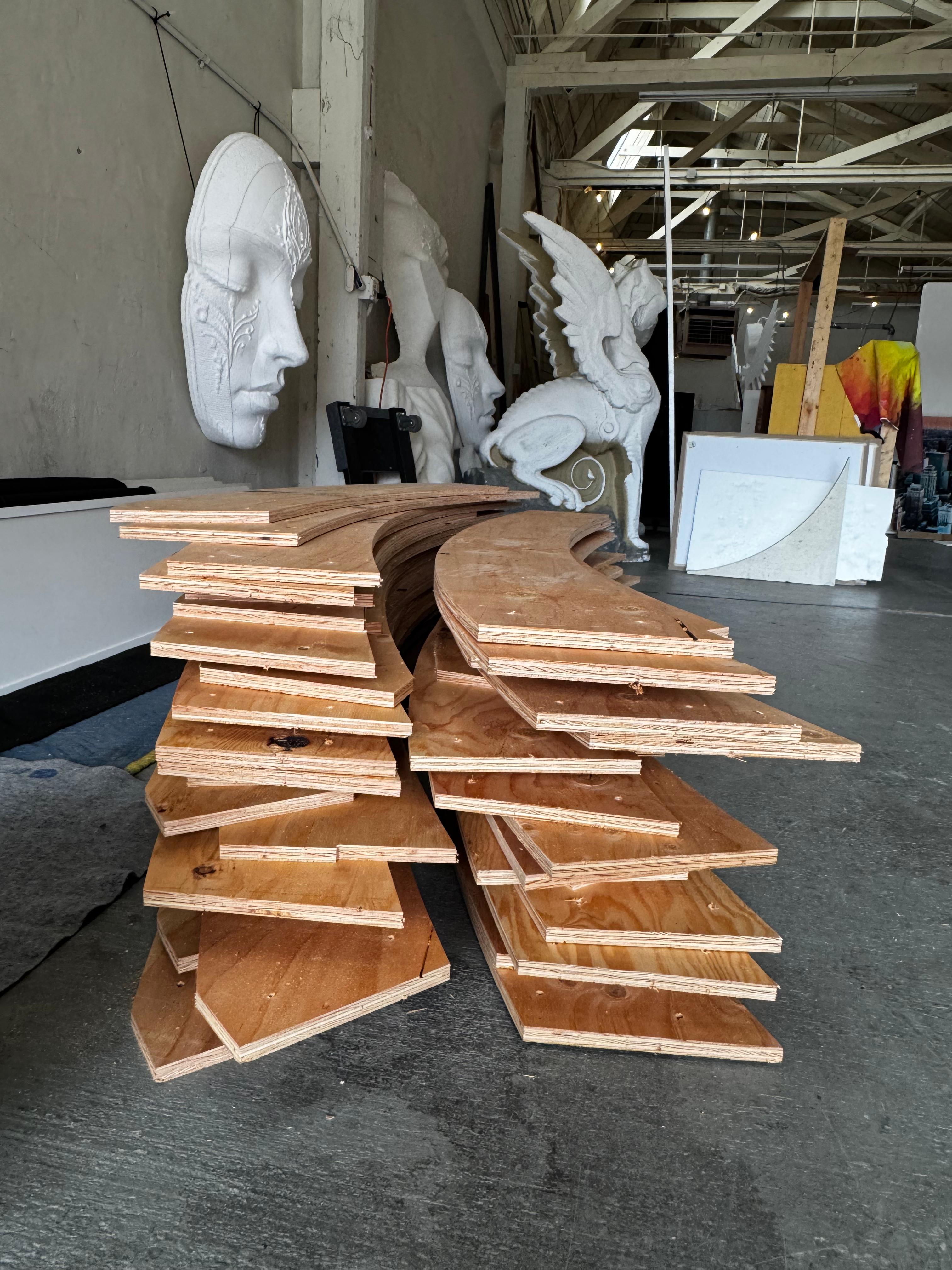 Stacked curved wooden pieces for the sanctuary build