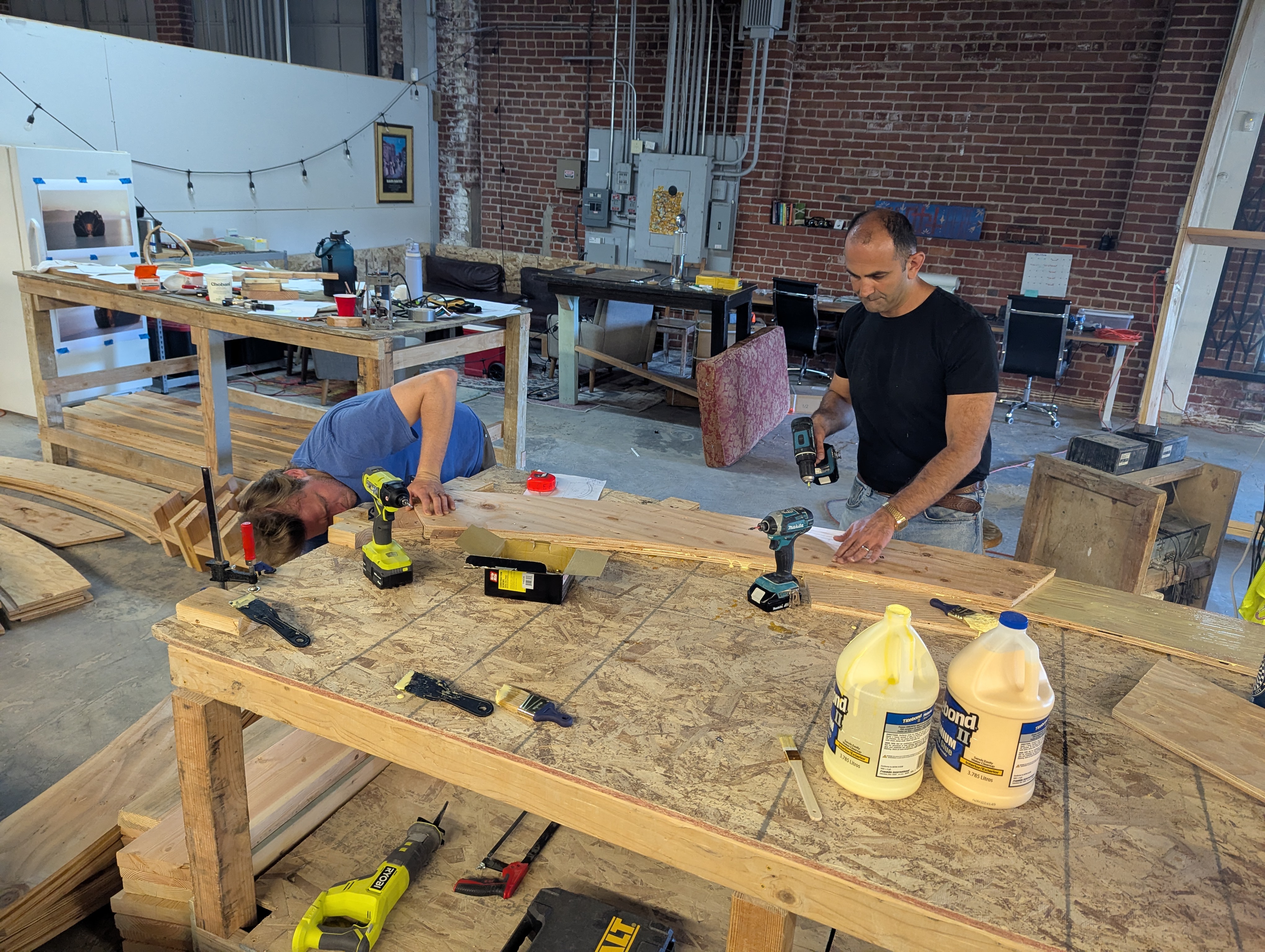 Hands-on fabrication work on a curved wooden piece